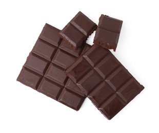 Photo of Pieces of delicious dark chocolate bar isolated on white, top view