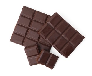 Photo of Pieces of delicious dark chocolate bar isolated on white, top view