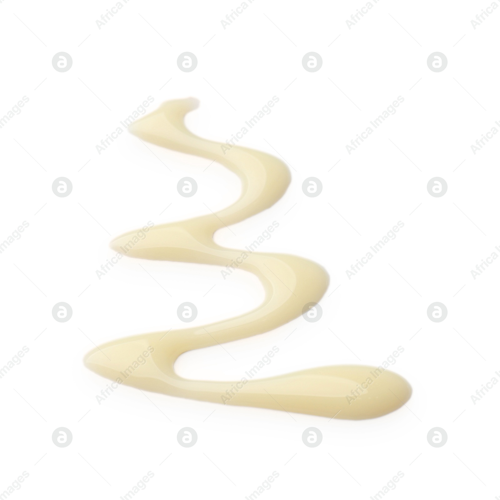 Photo of Spilled tasty condensed milk isolated on white