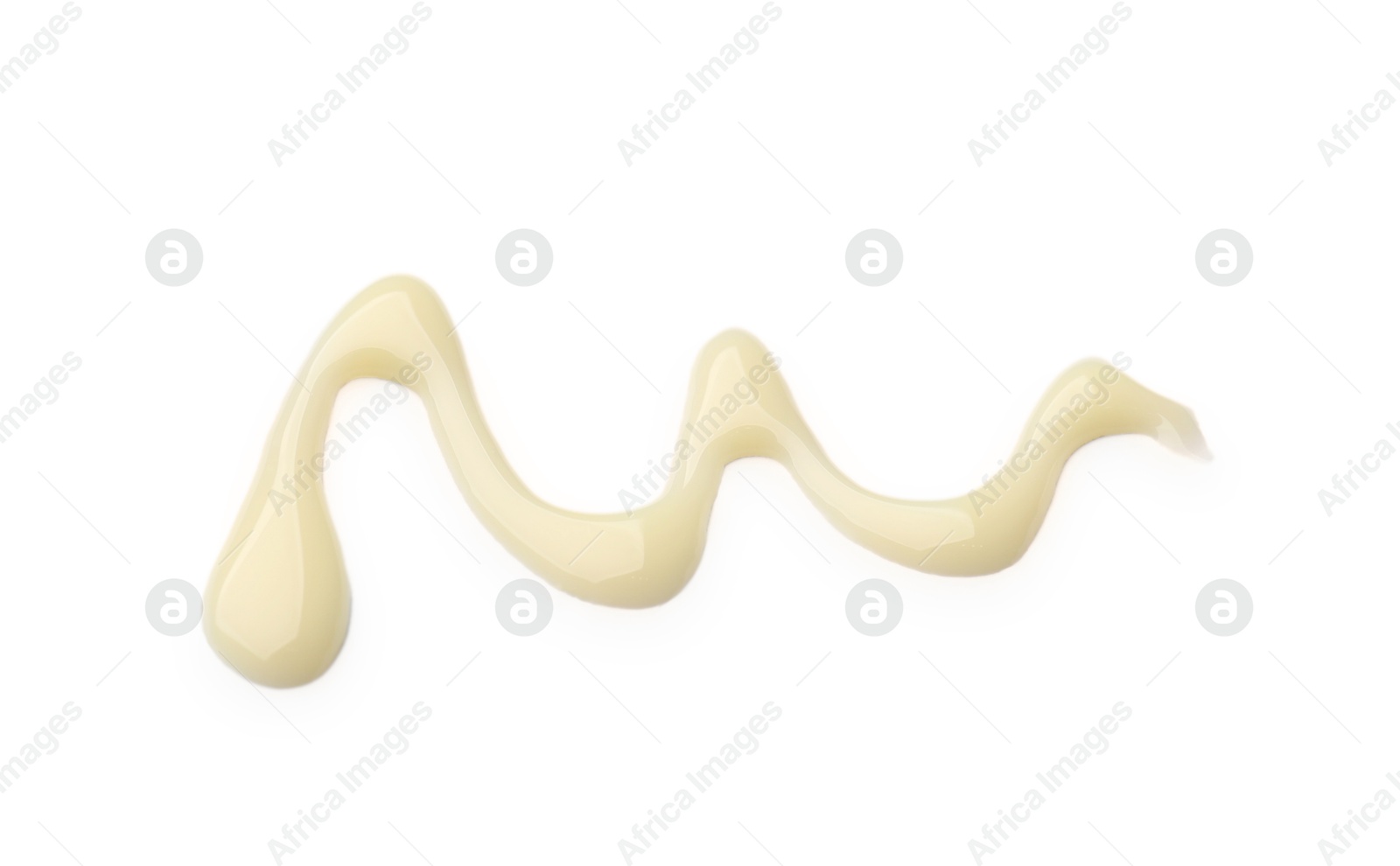 Photo of Spilled tasty condensed milk isolated on white, top view