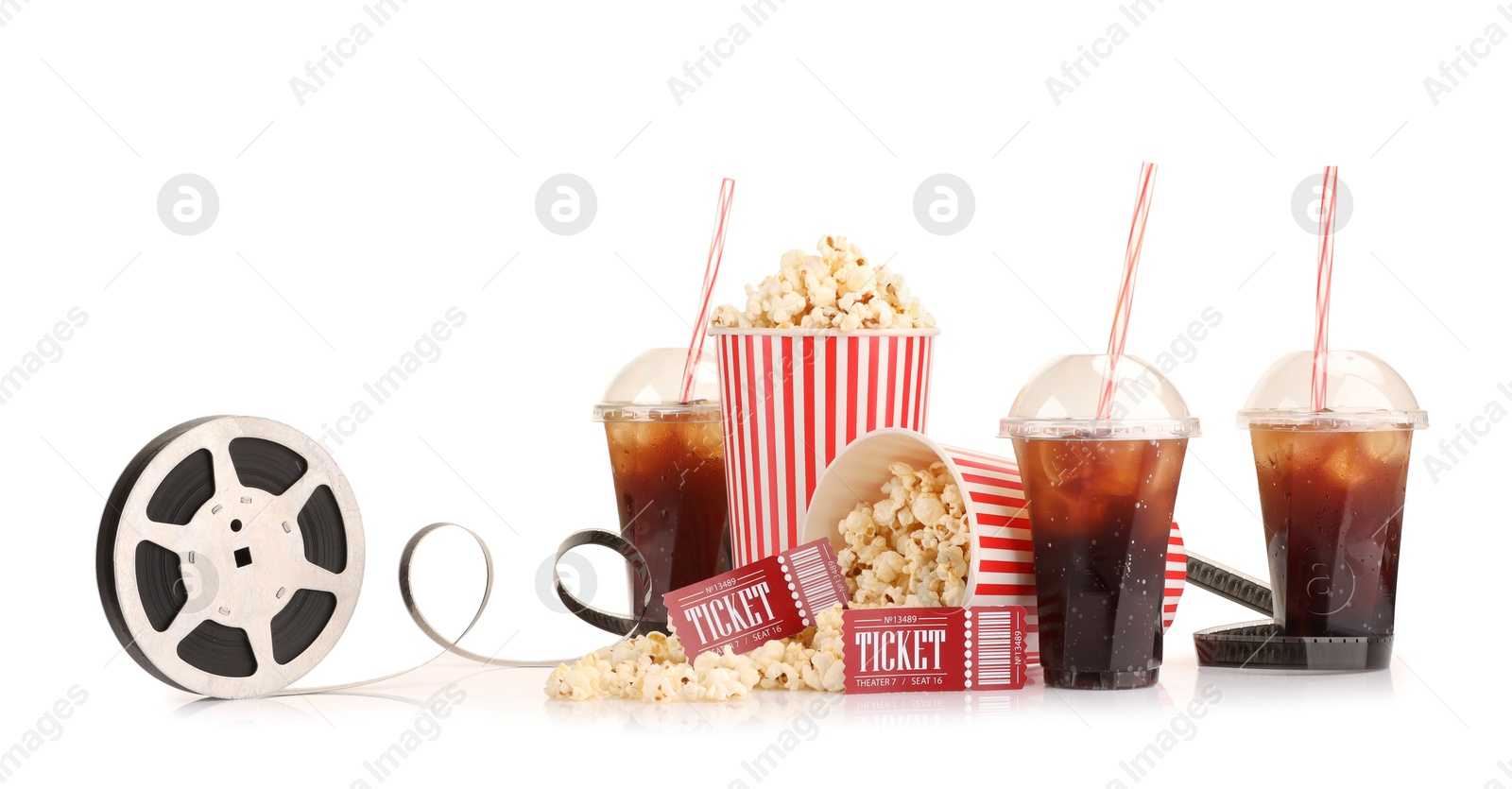 Photo of Tasty popcorn, film reel, soda drinks and movie tickets isolated on white