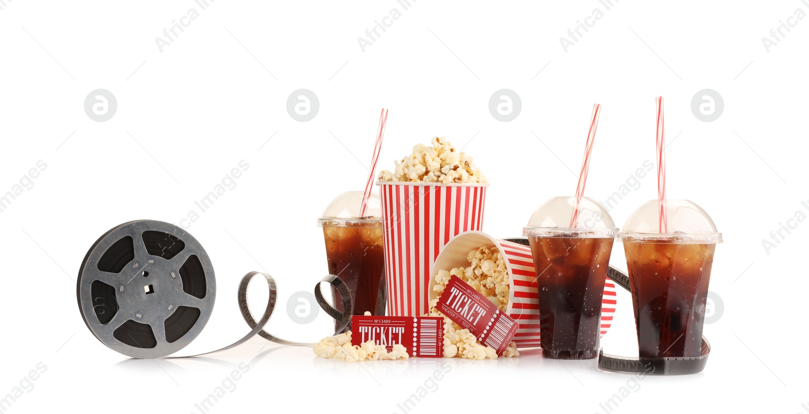 Photo of Tasty popcorn, film reel, soda drinks and movie tickets isolated on white