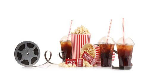 Photo of Tasty popcorn, film reel, soda drinks and movie tickets isolated on white