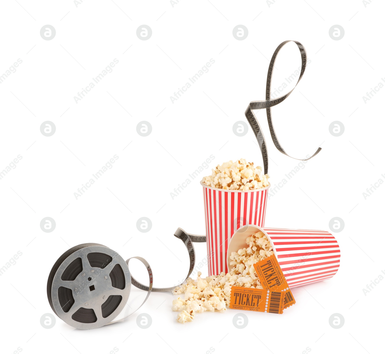 Photo of Tasty popcorn, film reel and movie tickets isolated on white