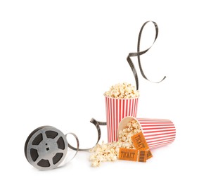 Photo of Tasty popcorn, film reel and movie tickets isolated on white