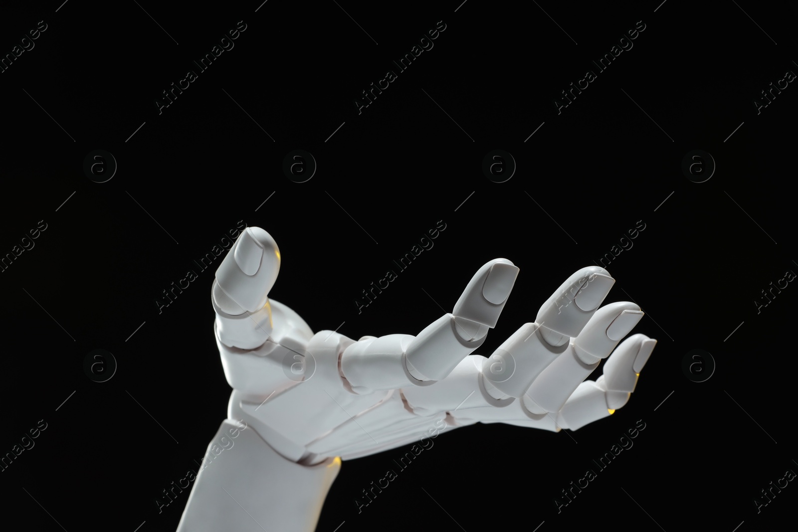 Photo of Artificial intelligence. Robot hand gesturing on black background