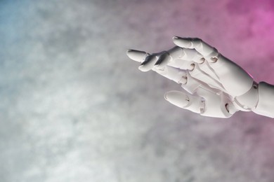 Photo of Artificial intelligence. Robot hand gesturing on grey blurred background, space for text