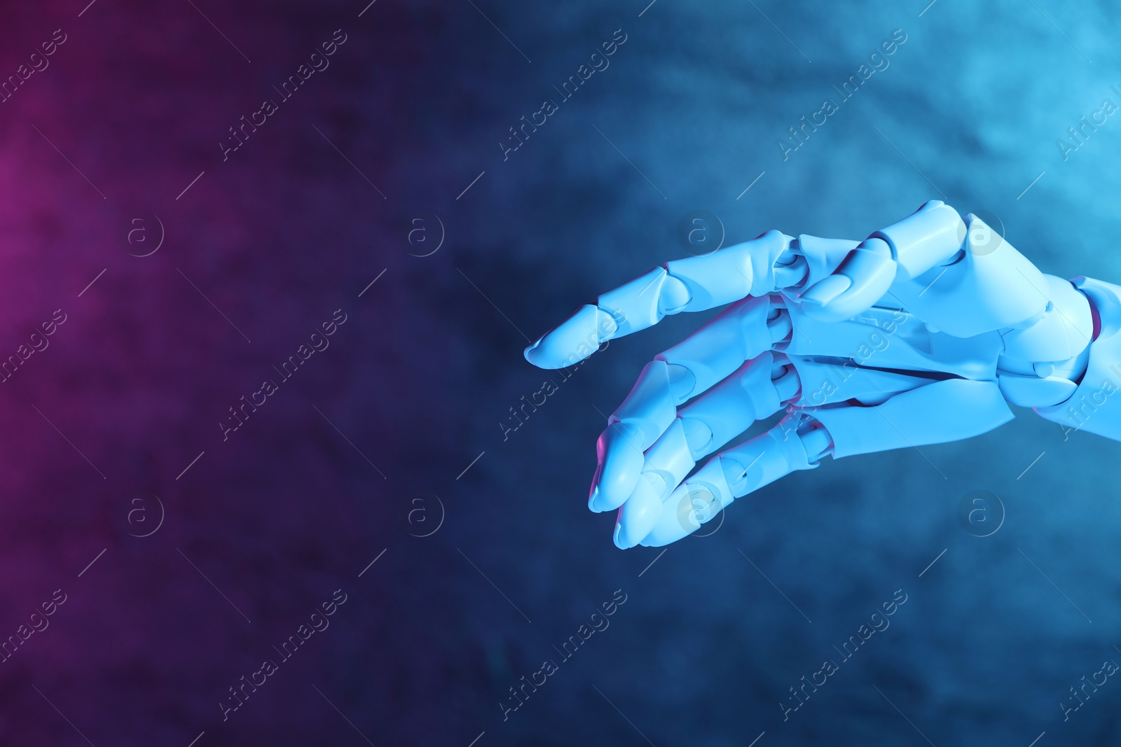 Photo of Artificial intelligence. Robot hand gesturing on blurred background in neon lights, space for text