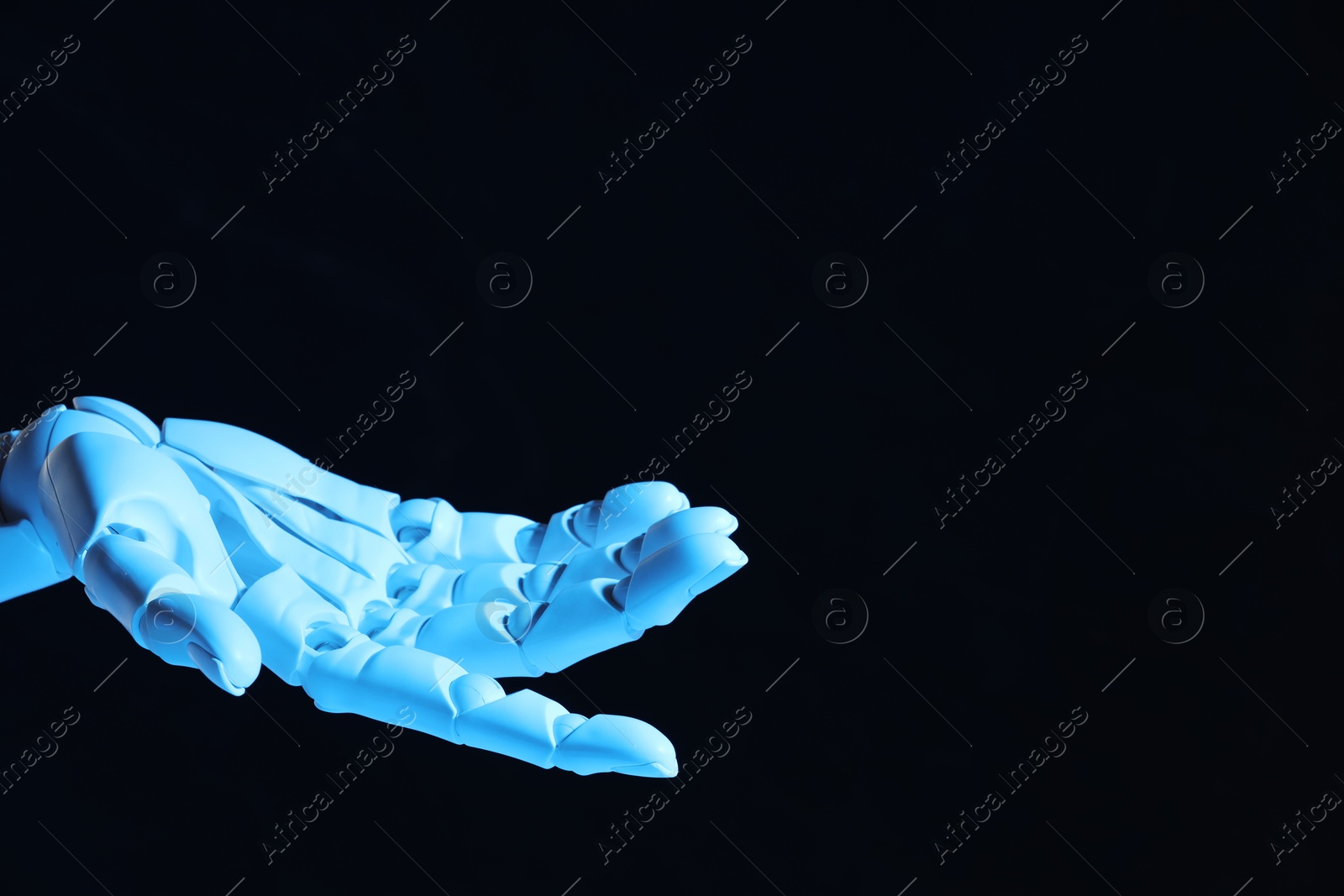 Photo of Artificial intelligence. Robot hand gesturing on dark background, space for text