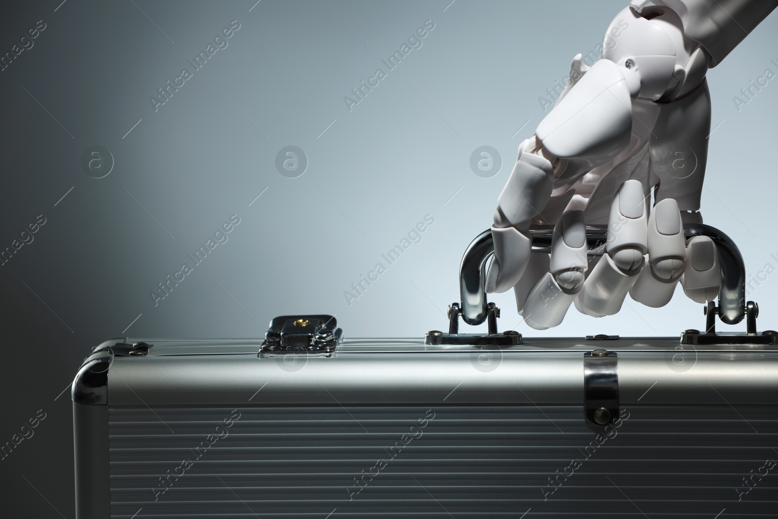 Photo of Artificial intelligence. Robot hand with metal case on grey background, closeup