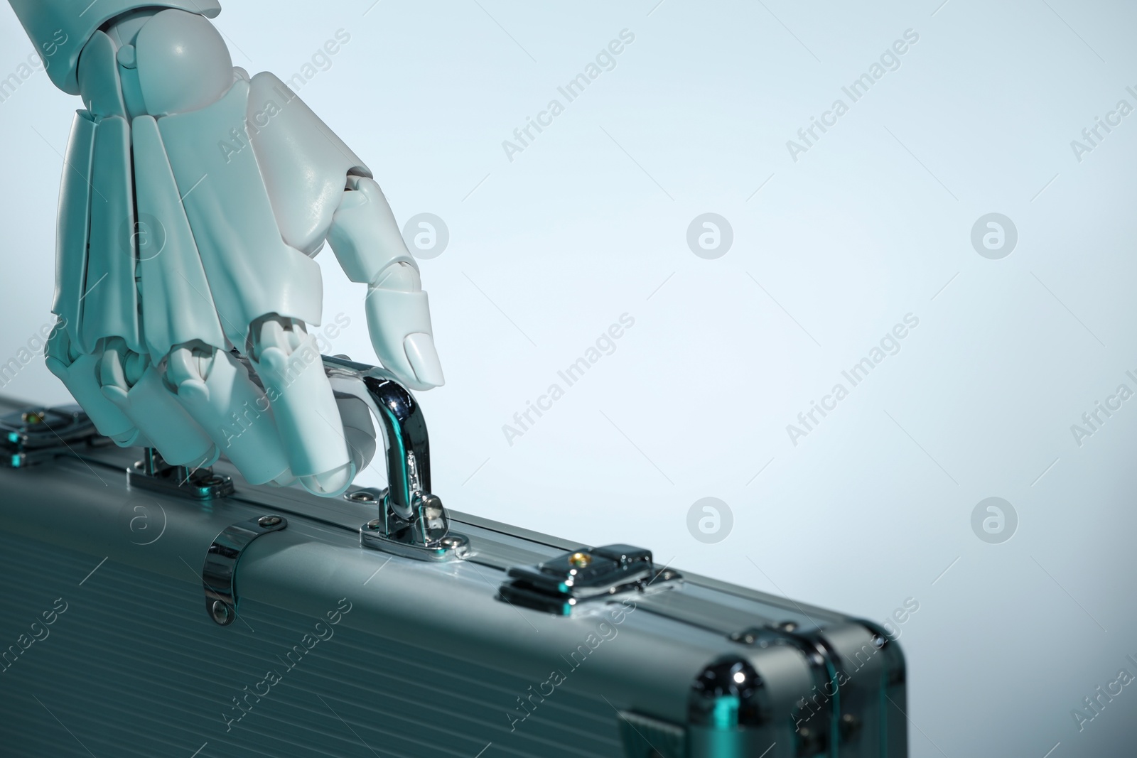 Photo of Artificial intelligence. Robot hand with metal case on light background, closeup