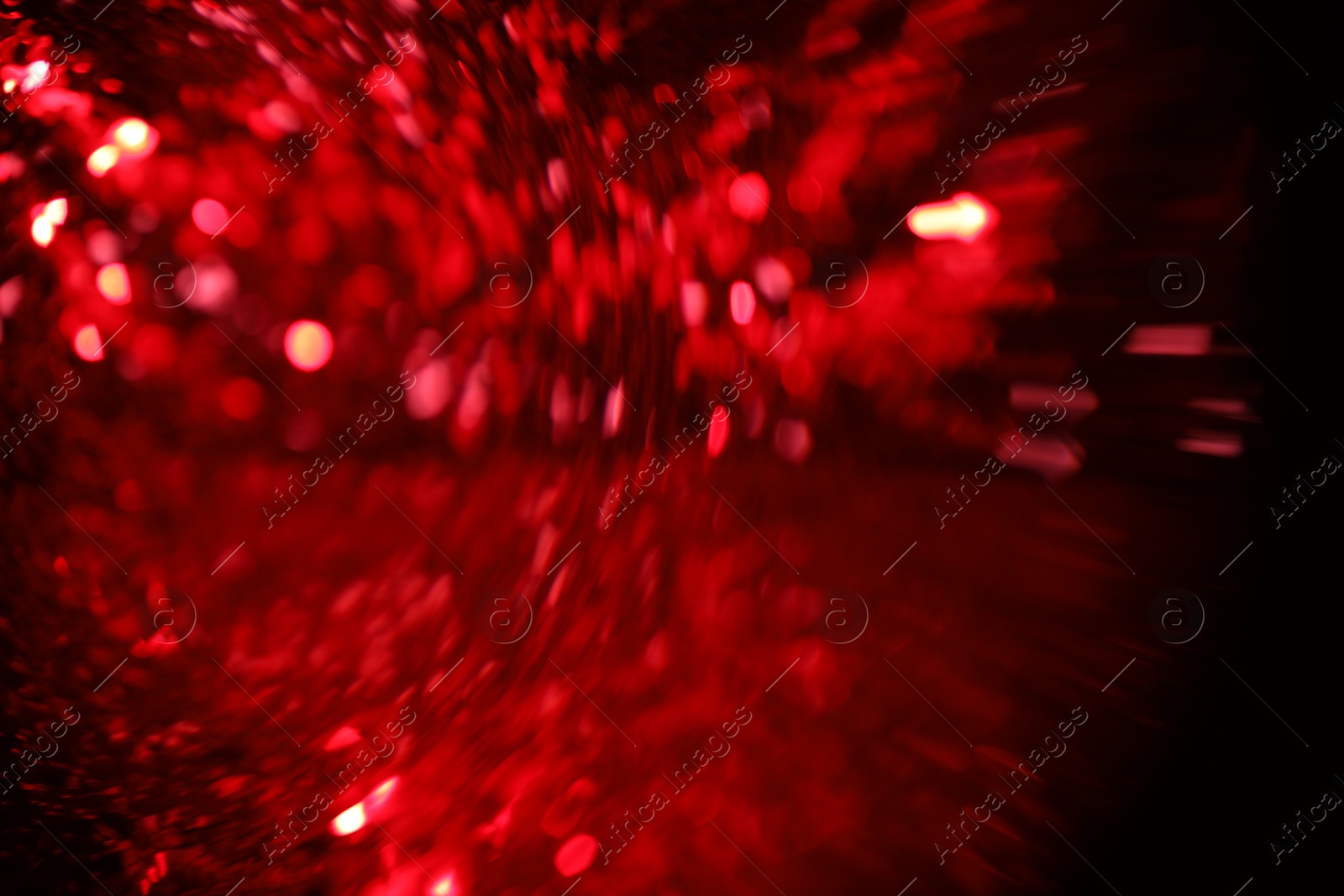 Photo of Blurred view of festive lights on black background. Bokeh effect