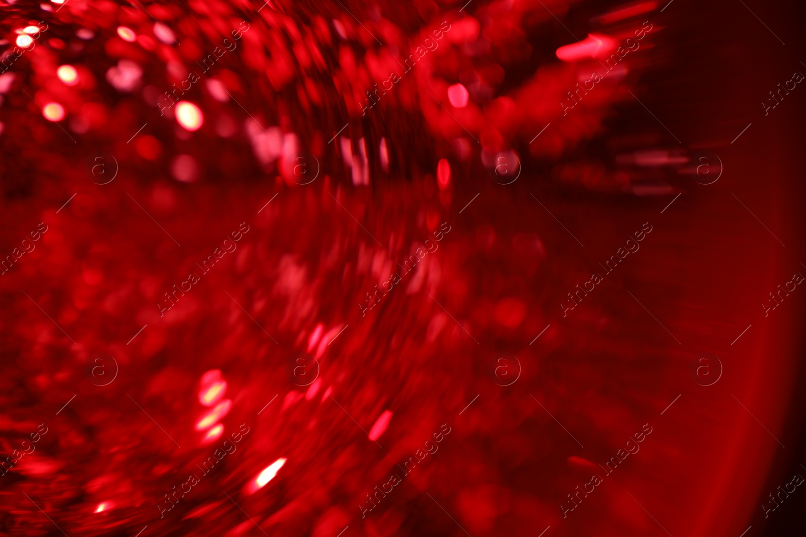 Photo of Blurred view of festive lights on red background. Bokeh effect