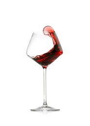 Photo of Red wine splashing in glass on white background