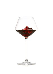 Photo of Red wine splashing in glass on white background