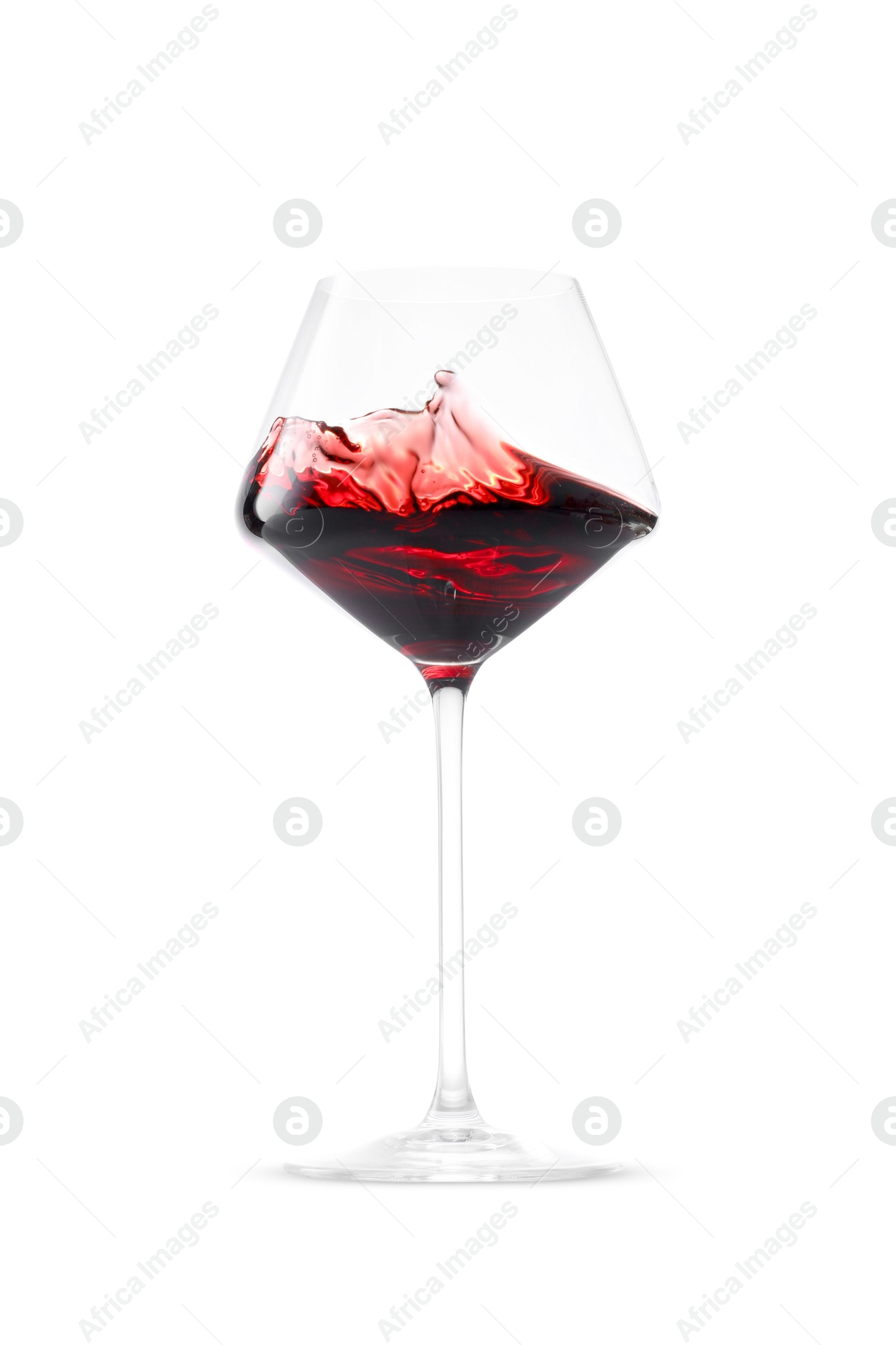 Photo of Red wine splashing in glass on white background