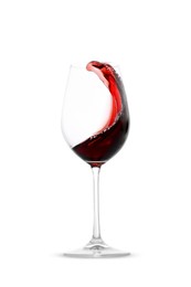 Photo of Red wine splashing in glass on white background