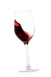 Photo of Red wine splashing in glass on white background