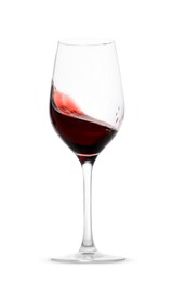 Photo of Red wine splashing in glass on white background