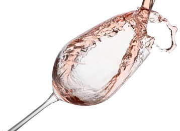 Photo of Pouring rose wine into glass isolated on white