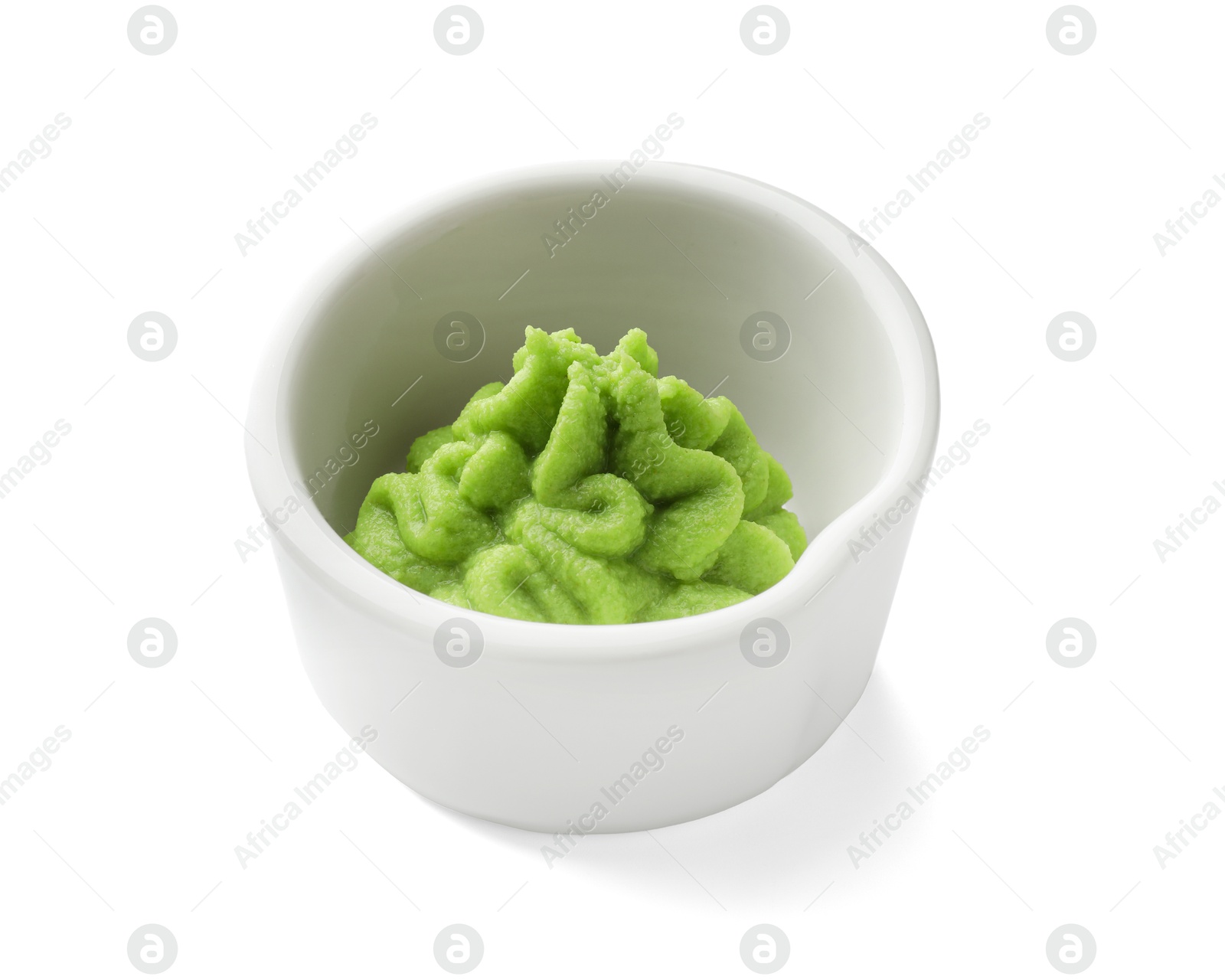 Photo of Hot wasabi paste in bowl isolated on white