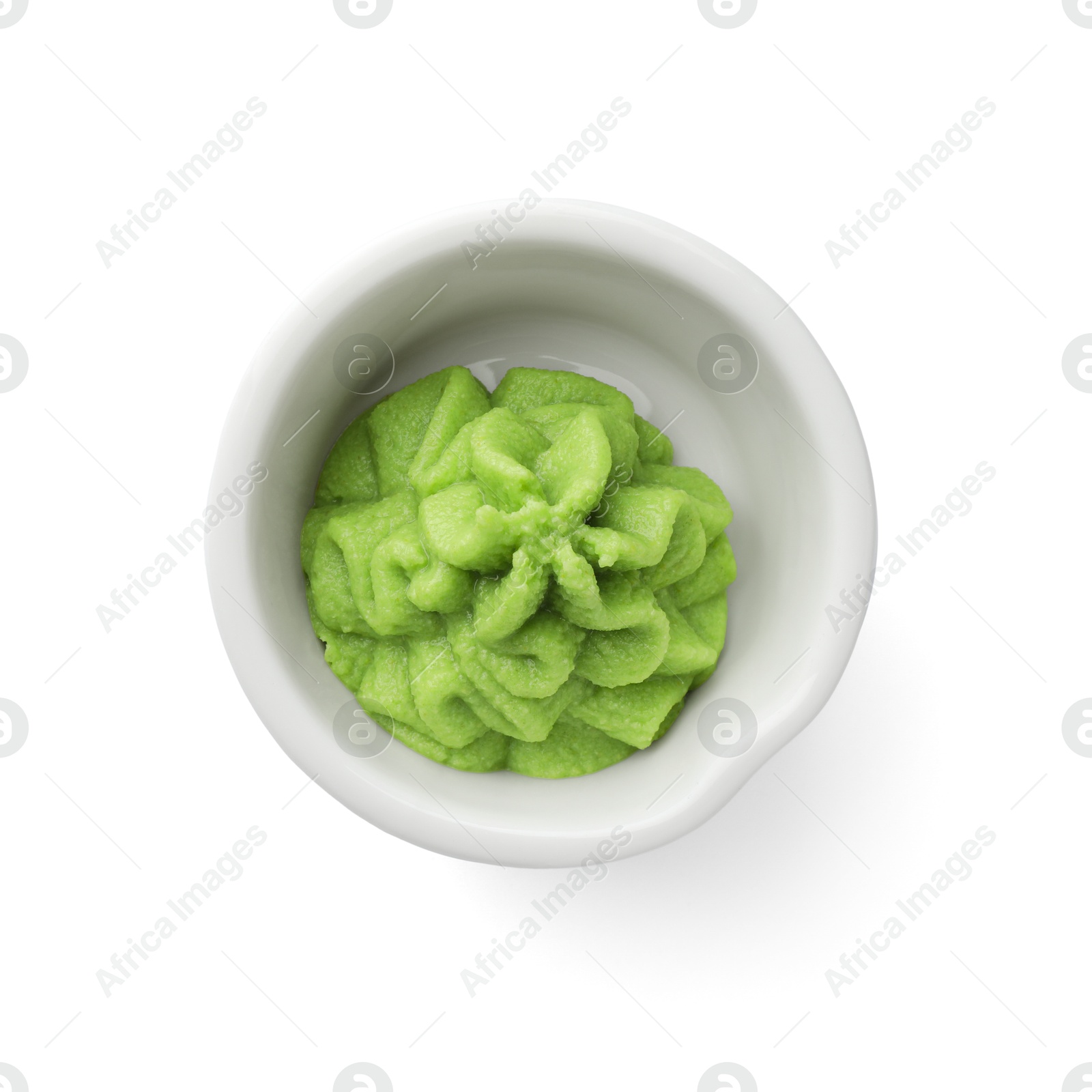 Photo of Hot wasabi paste in bowl isolated on white, top view