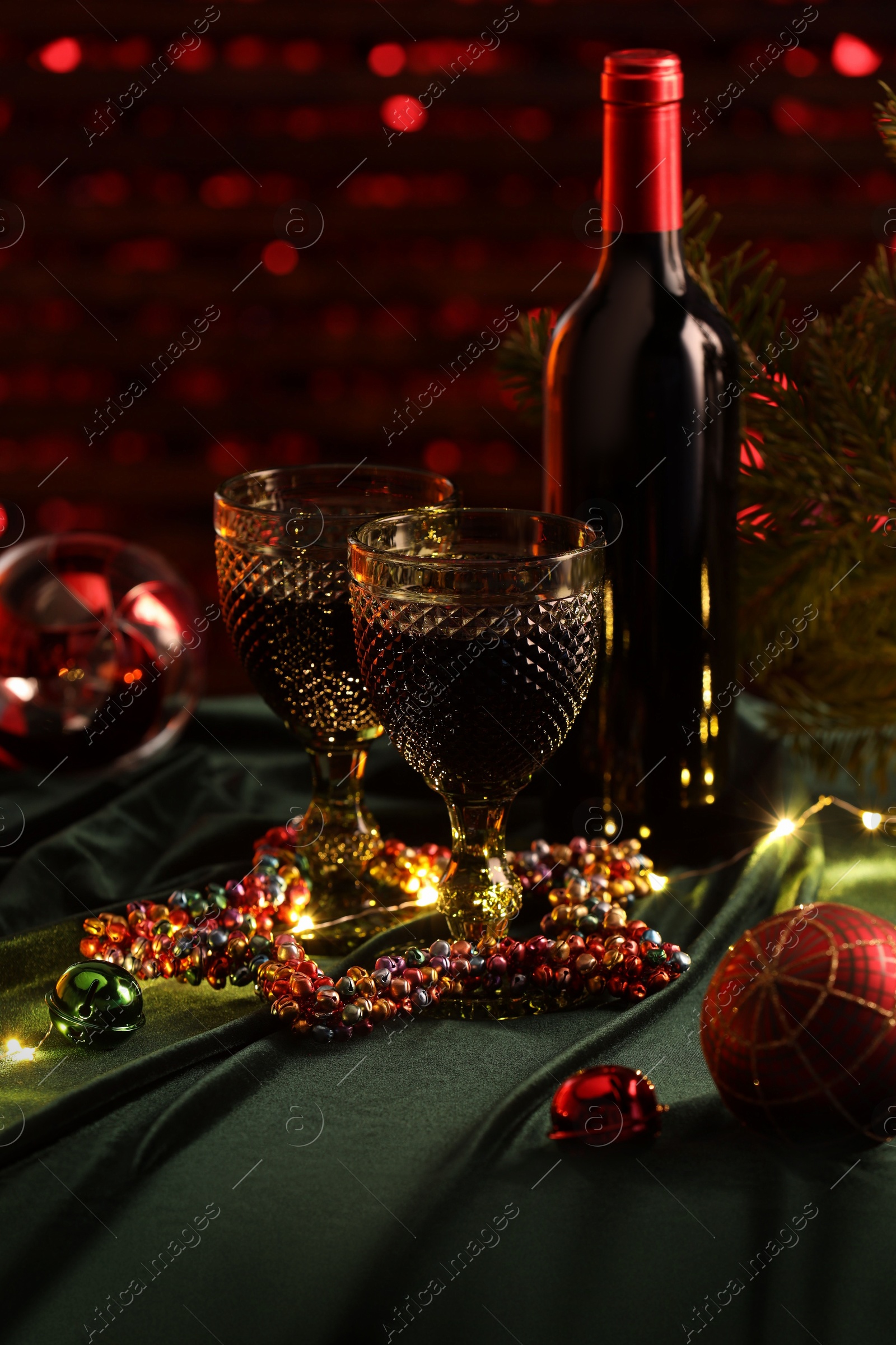 Photo of Red wine and beautiful Christmas decor on table