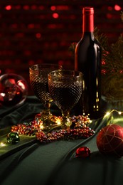 Photo of Red wine and beautiful Christmas decor on table