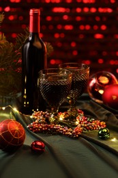 Photo of Red wine and beautiful Christmas decor on table