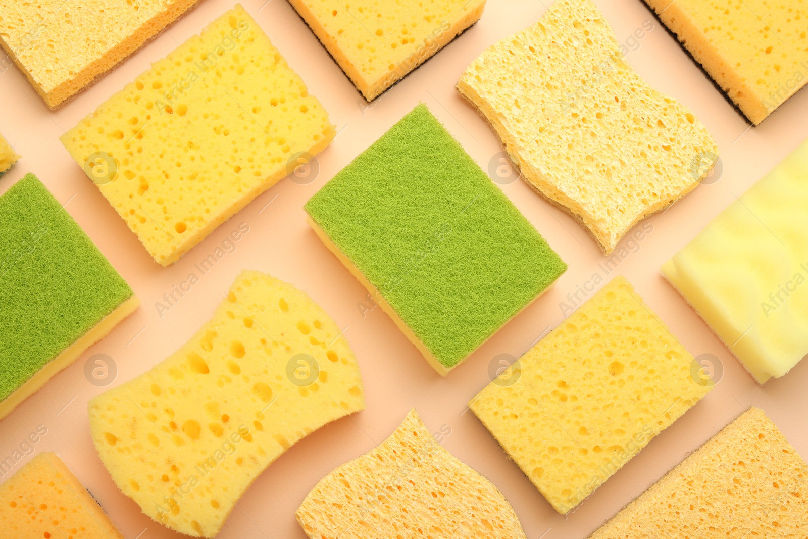 Photo of Many colorful sponges on beige background, flat lay