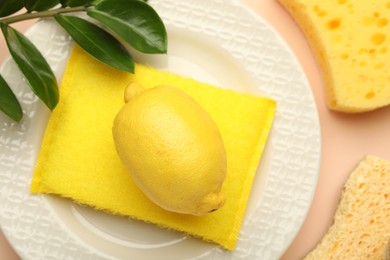 Photo of Flat lay composition with sponges and plate on beige background