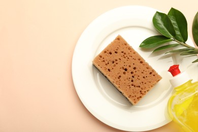 Photo of Sponge, detergent and plate on beige background, flat lay. Space for text