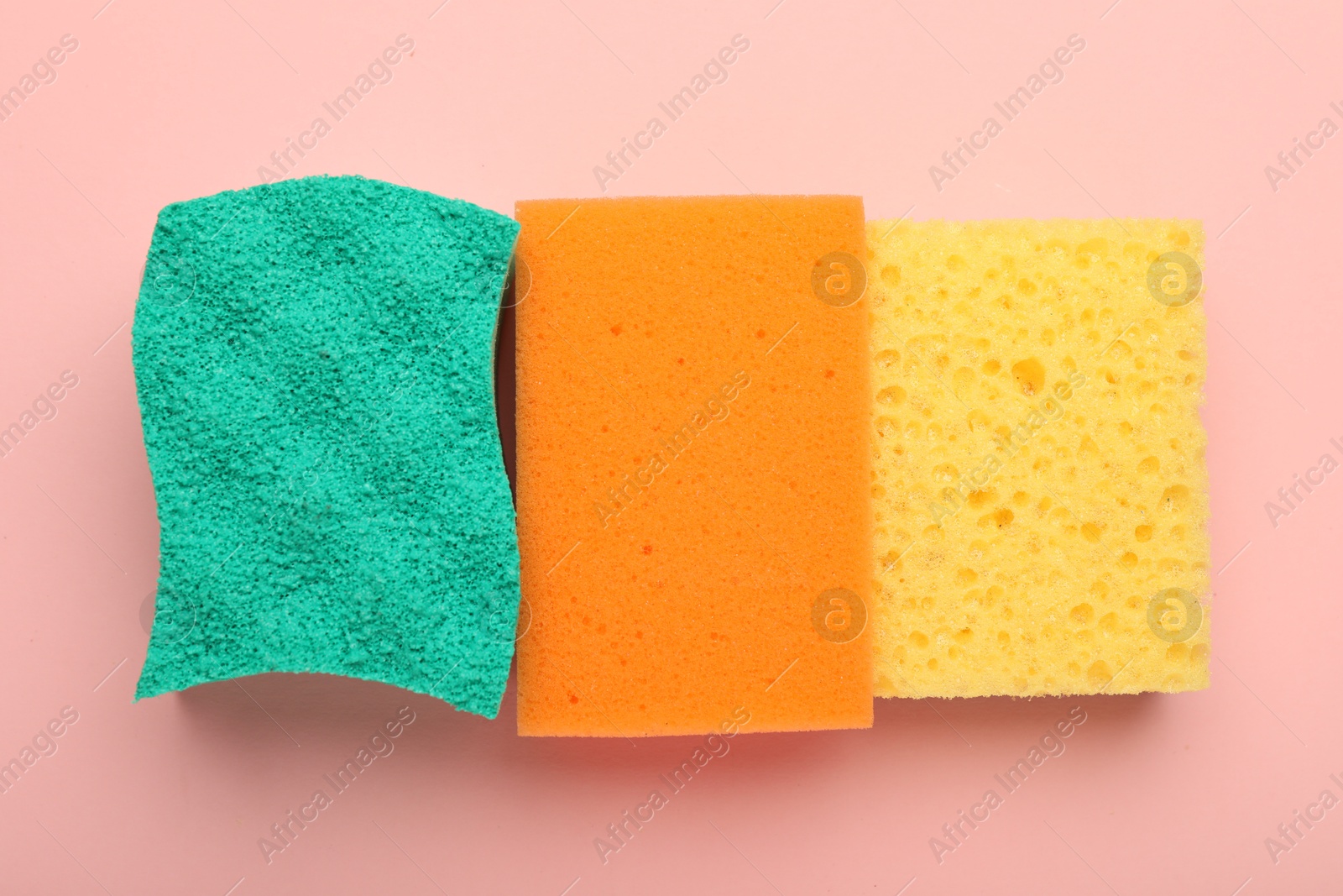 Photo of Color sponges on pink background, top view