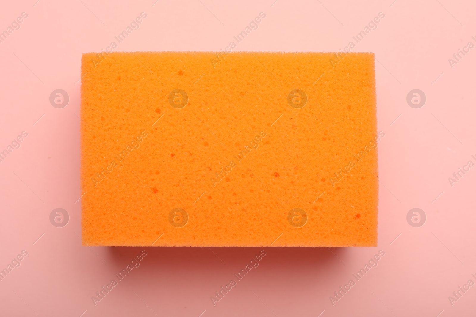 Photo of One sponge on pink background, top view