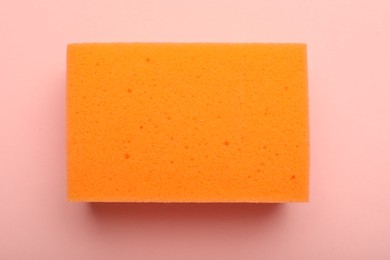 One sponge on pink background, top view