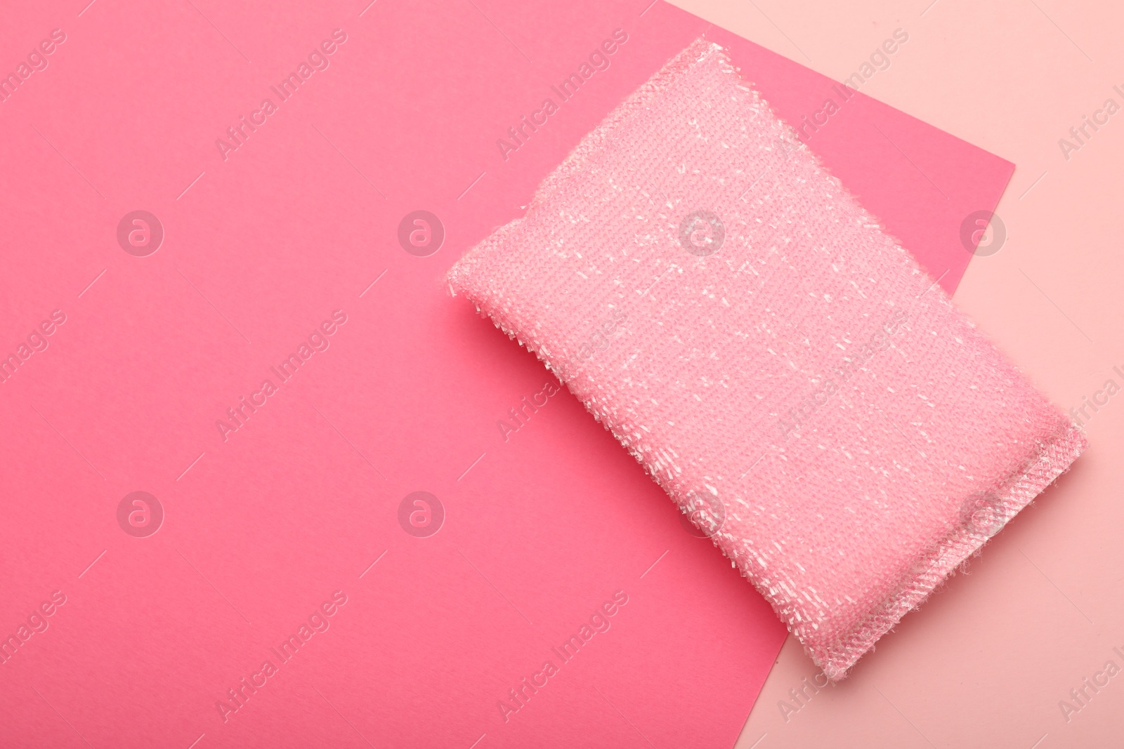 Photo of One sponge on pink background, top view. Space for text