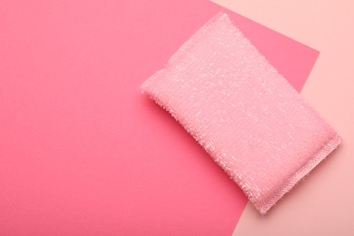 Photo of One sponge on pink background, top view. Space for text