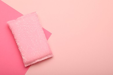 Photo of One sponge on pink background, top view. Space for text