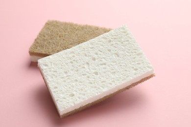 Photo of Two sponges on pink background, closeup view