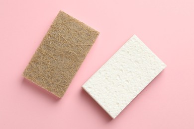 Photo of Two sponges on pink background, top view