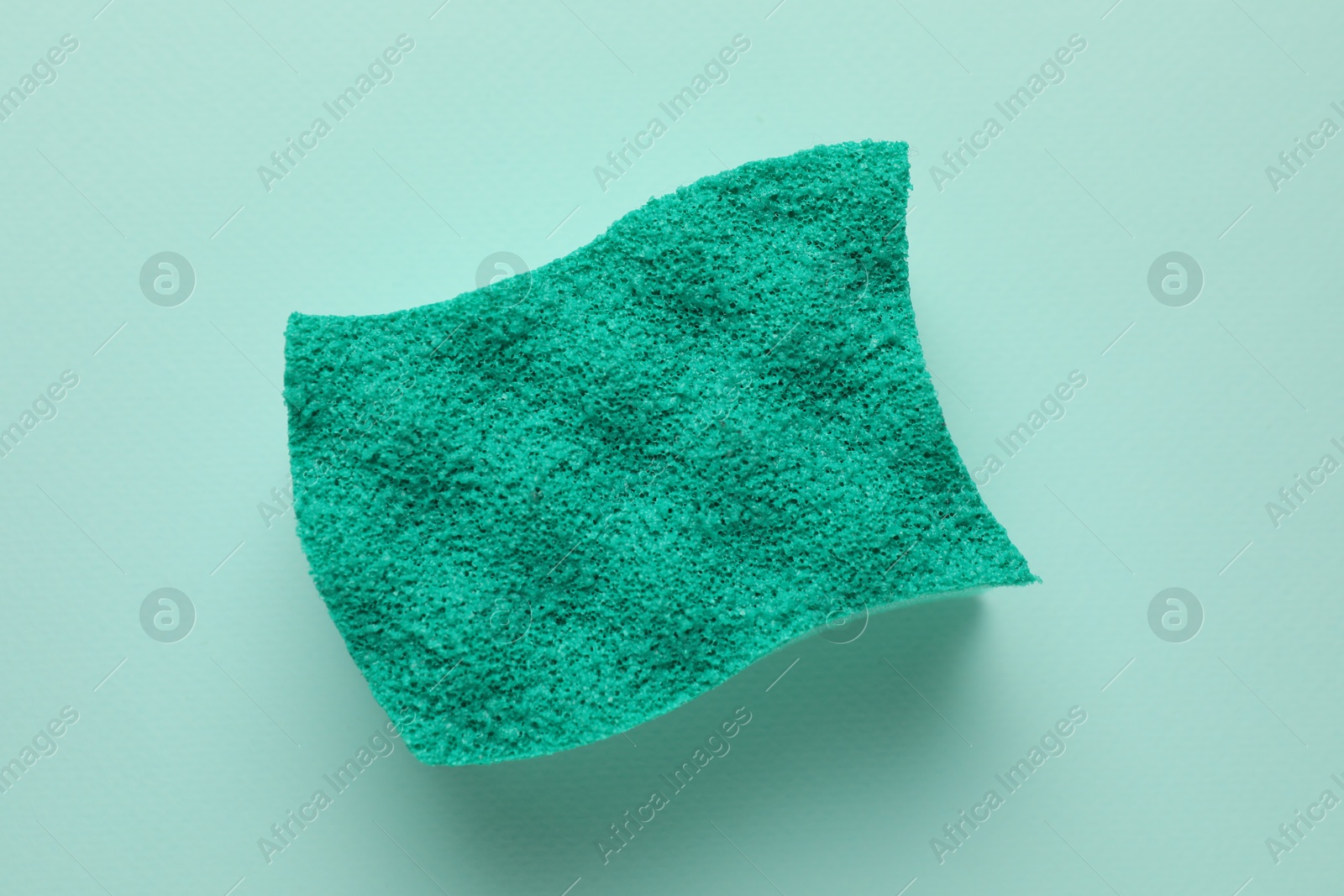 Photo of One sponge on light blue background, top view