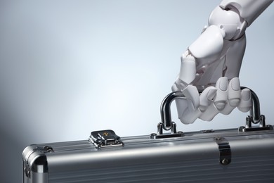 Photo of Artificial intelligence. Robot hand with metal case on grey background, closeup