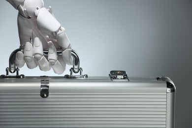 Photo of Artificial intelligence. Robot hand with metal case on grey background, closeup