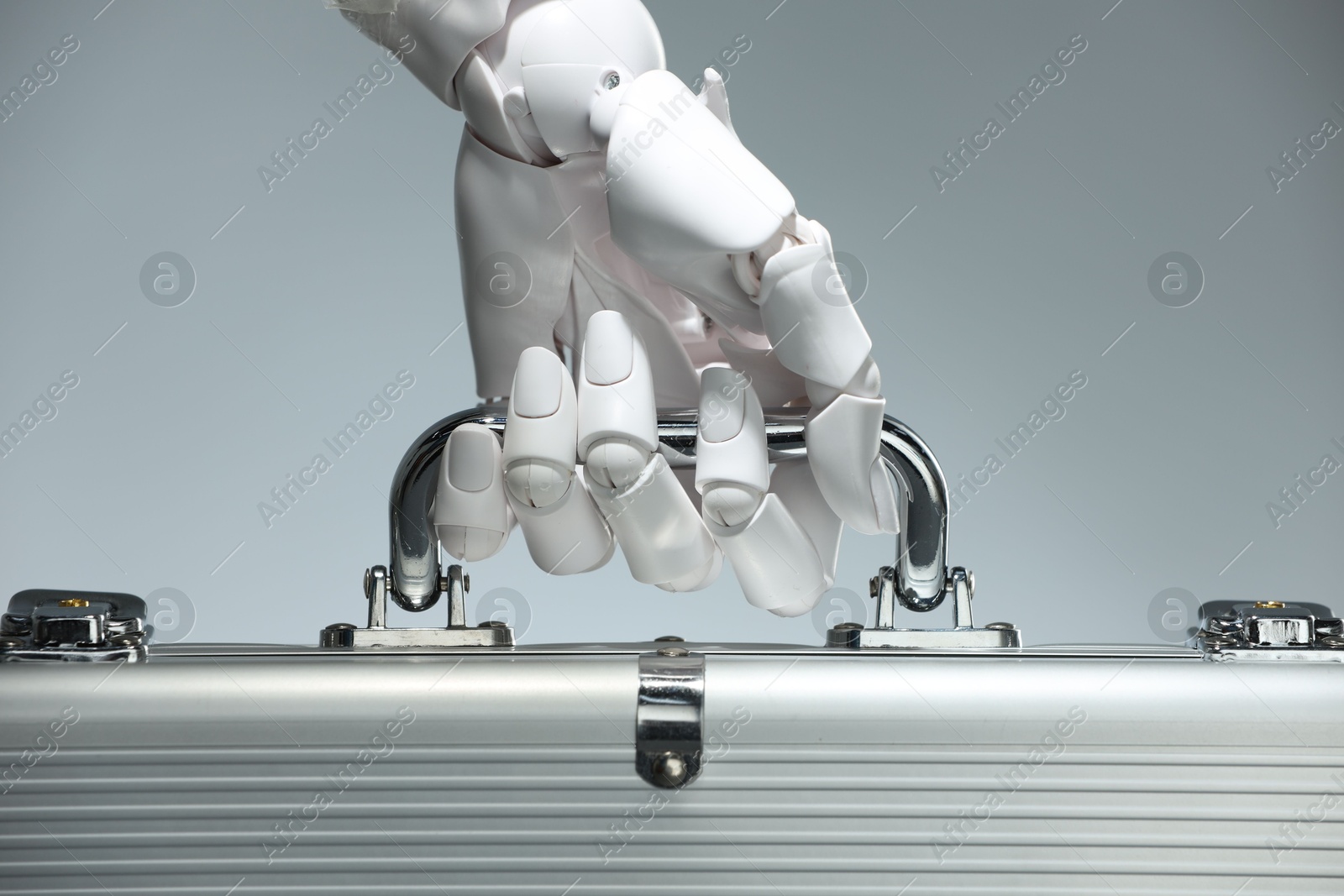 Photo of Artificial intelligence. Robot hand with metal case on grey background, closeup