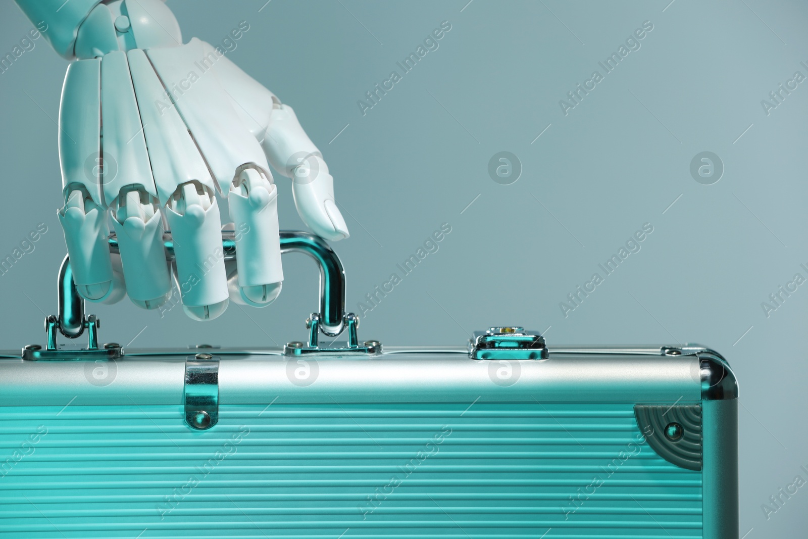 Photo of Artificial intelligence. Robot hand with metal case on grey background, closeup