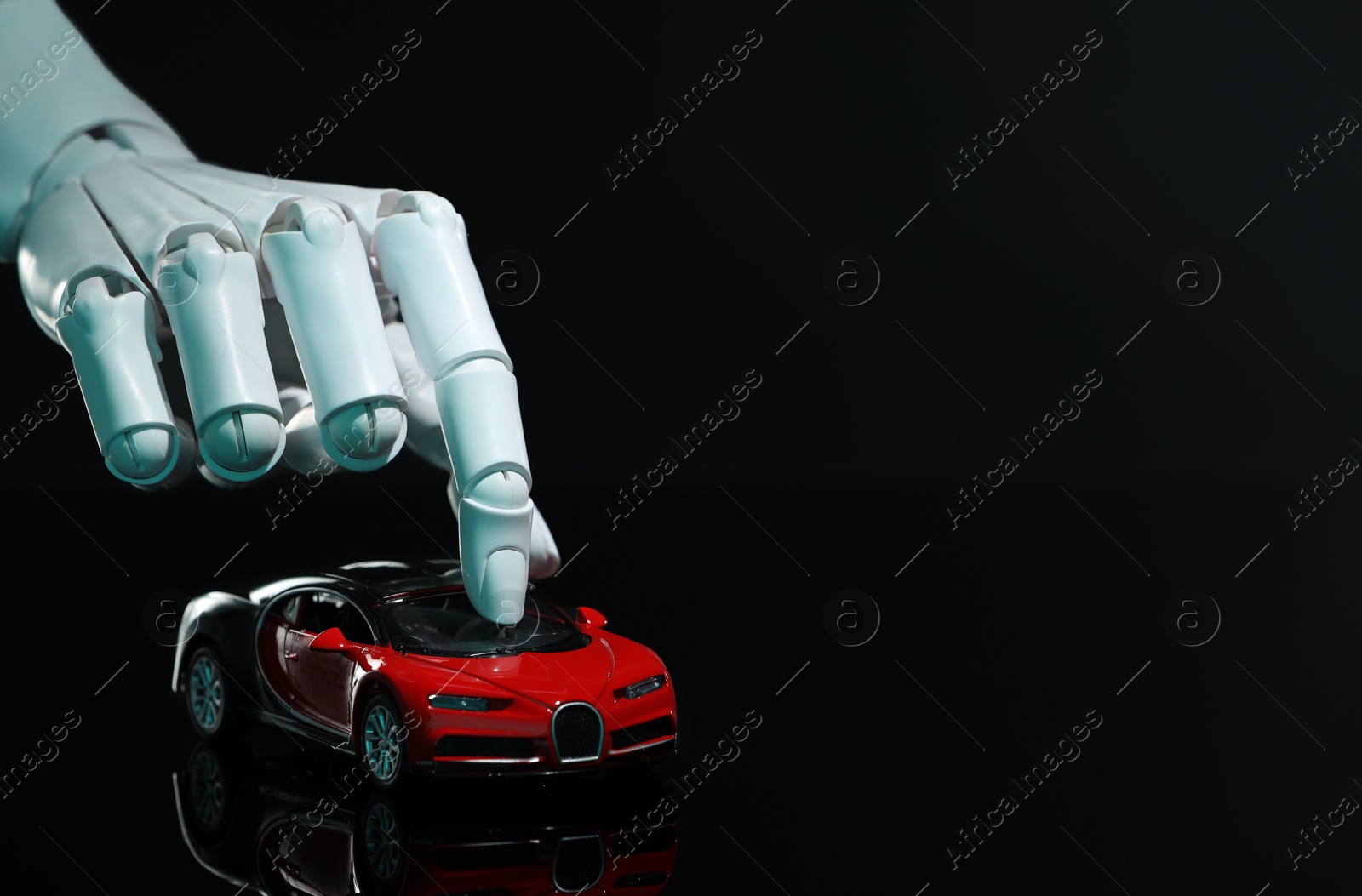 Photo of Artificial intelligence. Robot hand with toy car against black background, closeup. Space for text