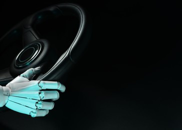 Photo of Artificial intelligence. Robot hand with steering wheel on black background, closeup. Space for text