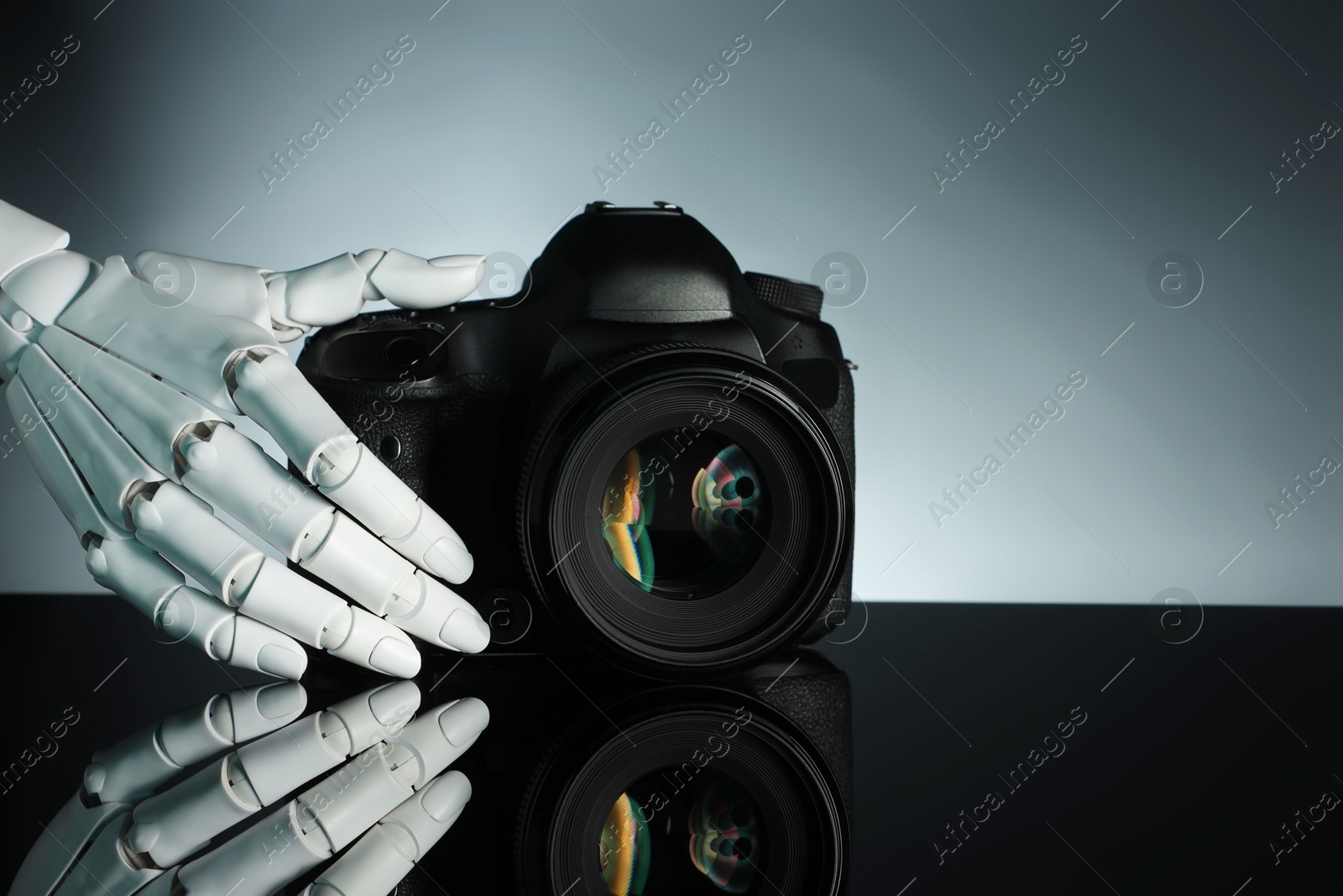 Photo of Artificial intelligence. Robot hand with photo camera against grey background, closeup. Space for text