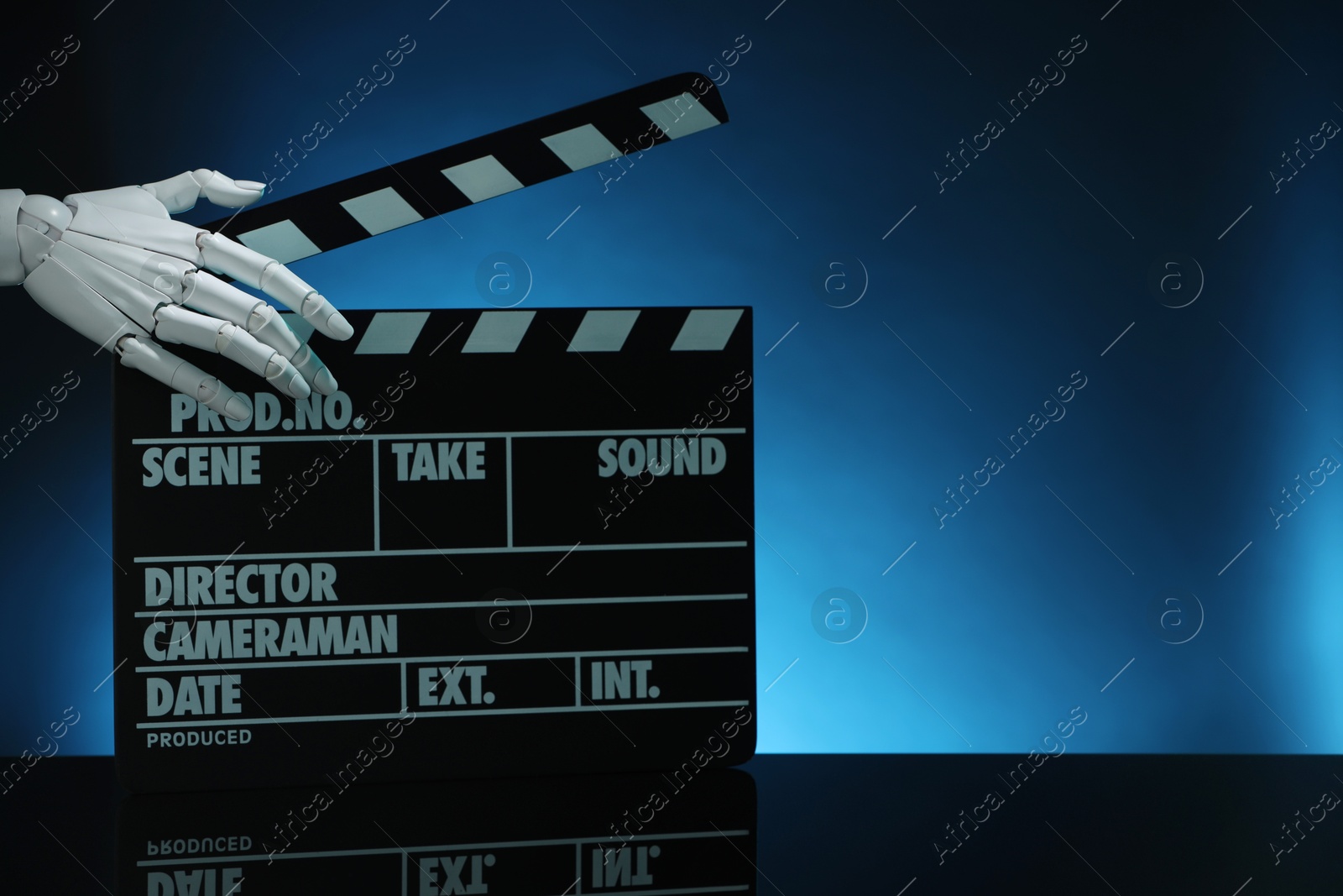 Photo of Artificial intelligence. Robot hand with clapper against dark blue background, closeup. Space for text