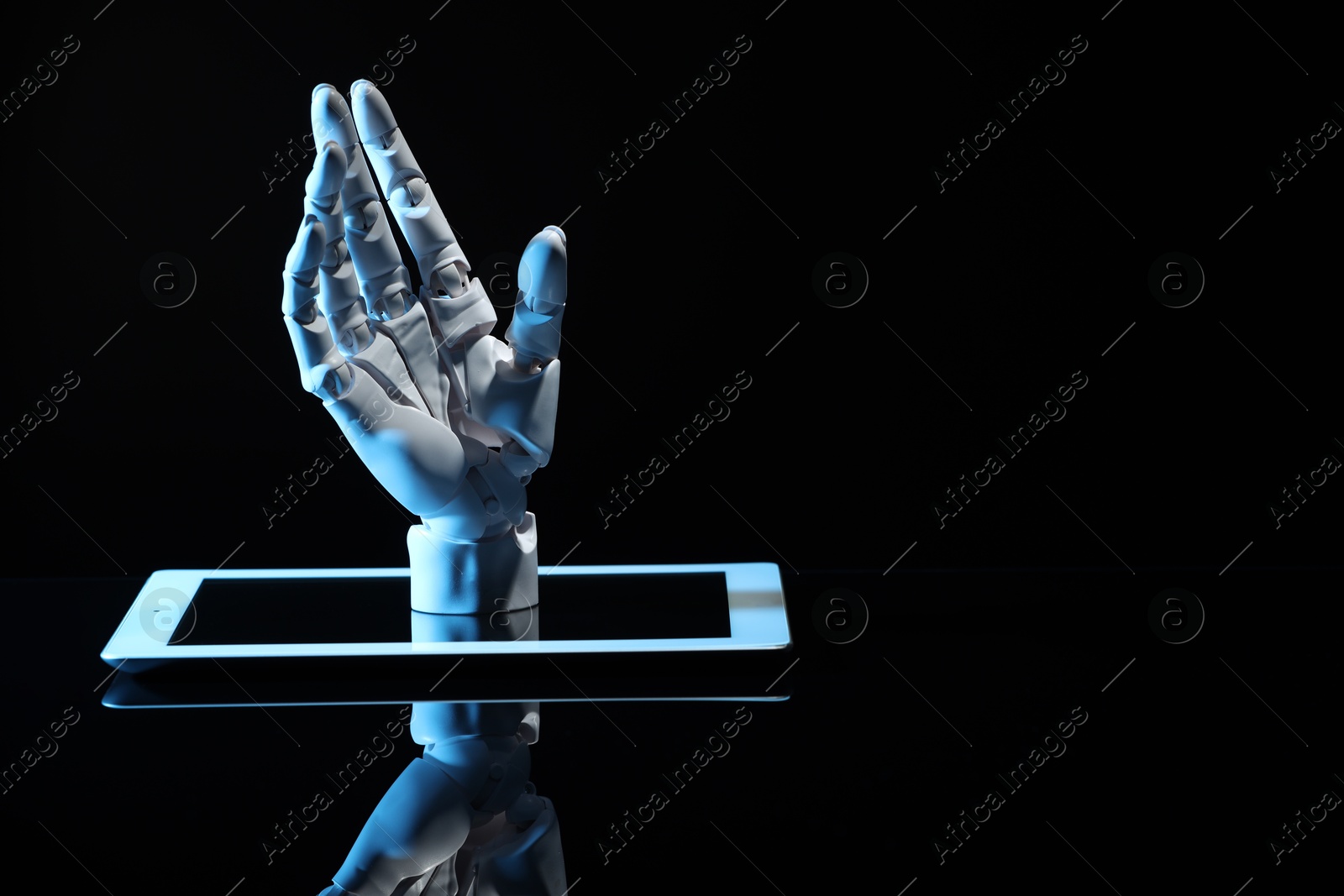 Photo of Artificial intelligence. Robot hand and tablet on black glass surface, space for text